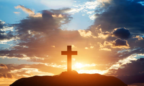 istock Religious cross on the hill at sunset 1351502618