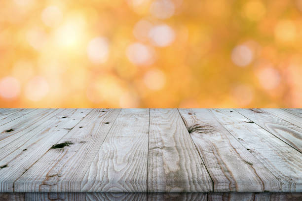 istock Empty wooden table top with autumn background. 1351502644