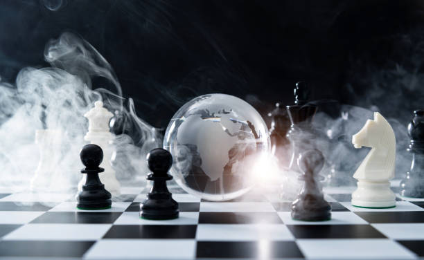 istock Glass earth globe and chess pieces with smoke 1351502666