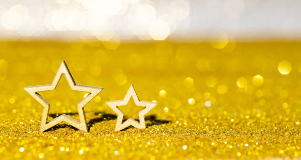 istock Christmas stars on shiny golden background 1351503732