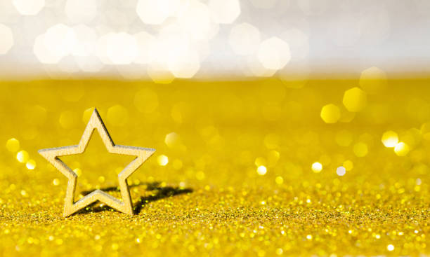 istock Christmas star on shiny golden background 1351503754