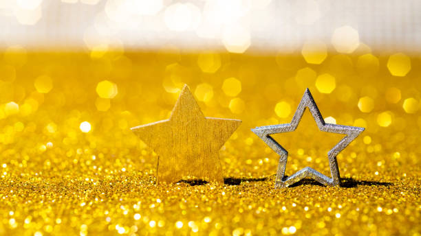 istock Christmas stars on shiny golden background 1351503770