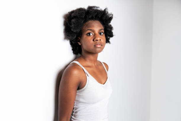 istock Young African Woman Isolated On White Background look no feeling 1351503832