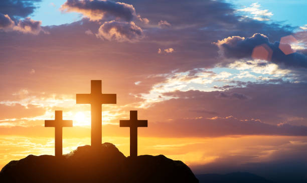 istock Religious cross on the hill at sunset 1351504375