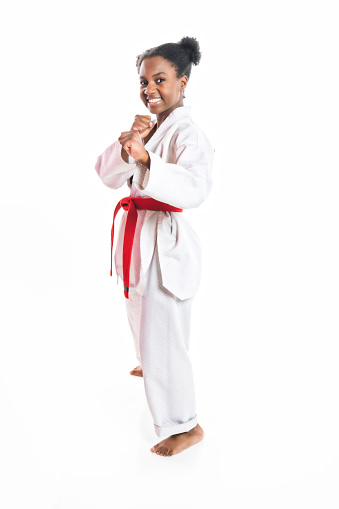 A Young black belt karate fighter training Isolated portrait on white background