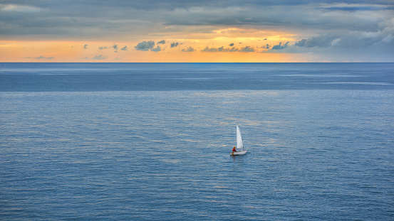sailing ship in the sea against the blue sky. dawn