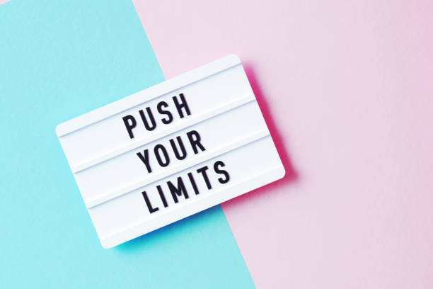 istock Push Your Limits Written White Lightbox Sitting On Pink And Blue Background 1351509053