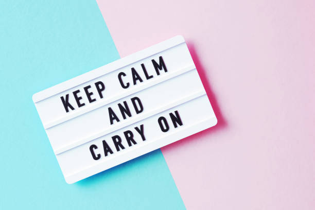 istock Keep Calm And Carry On Written White Lightbox Sitting On Pink And Blue Background 1351509159