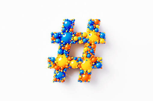 Colorful hashtag symbol made of many spheres sitting on white background. Horizontal composition with clipping path and copy space. Directly above.