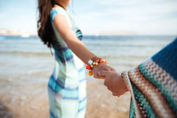 istock Cropped image of two girls holding hands 1351514437
