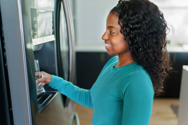 istock Young Woman on front of Fridge At Kitchen 1351514665