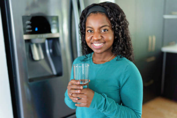 istock Young Woman on front of Fridge At Kitchen 1351514673