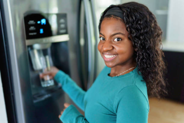istock Young Woman on front of Fridge At Kitchen 1351514680