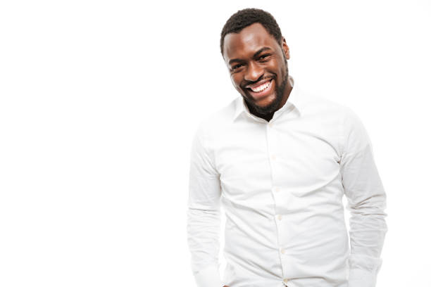 Photo of smiling young african man dressed in shirt standing isolated over white background.