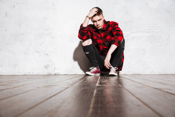 istock Hipster in shirt posing and sitting 1351518794
