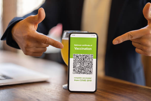 istock Man show phone with app of Coronavirus Vaccination 1351519934