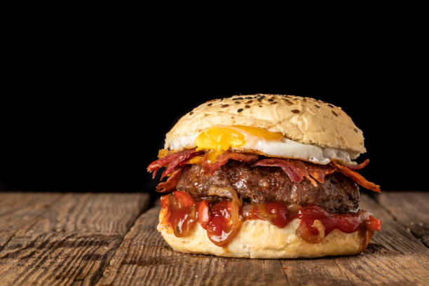 istock Burger with egg bacon onion and french fries 1351520178