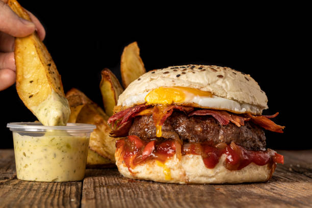 istock Burger with egg bacon onion and french fries 1351520292