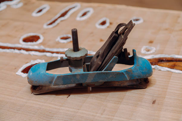 istock Old metallic jointer plane laying on wood table 1351520622