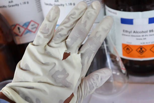 istock Use torn gloves when working with hazardous chemical in the laboratory or industry 1351521534