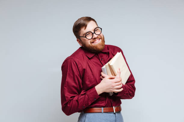 istock Happe Male nerd with books 1351521954