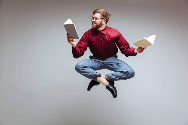 istock Male nerd jumping and reading in-flight 1351523062