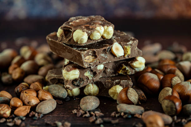 istock Chocolate with peanuts pieces and cocoa beans. 1351529036