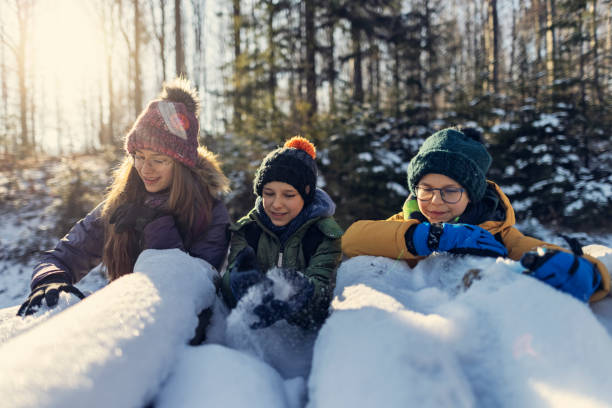 istock Children enjoying hiking in winter forest. 1351530151