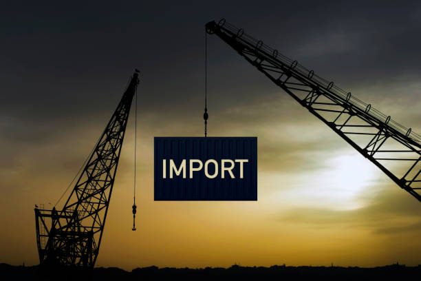 Shore crane loading containers in freight ship