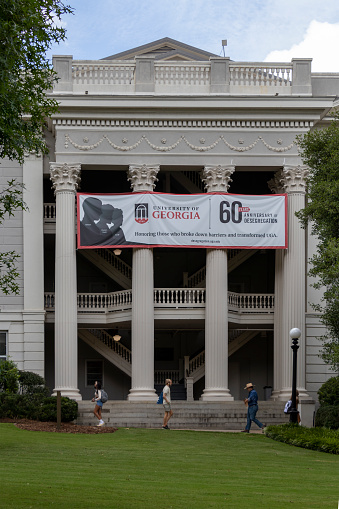 Athens, Georgia - August 27, 2021: The Holmes-Hunter Academic Building, named after Charlayne Hunter and Hamilton Holmes, the first two African American students admitted to the University of Georgia, displays a banner on the 60th anniversary of the institution's desegregation.