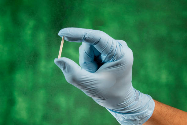 hand in rubber gloves holding a hormonal implant. Hormonal implant or beauty chip is a subcutaneous application. hormone stock pictures, royalty-free photos & images