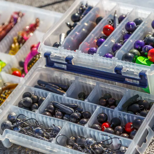 Photo of A large fisherman's tackle box fully stocked with lures and gear for fishing.fishing lures and accessories in the box background.