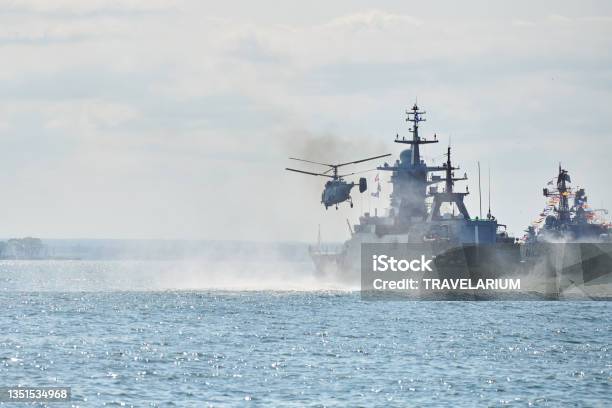 Battleships War Ships Corvette During Naval Exercises And Helicopter Maneuvering Over Sea Warships Stock Photo - Download Image Now