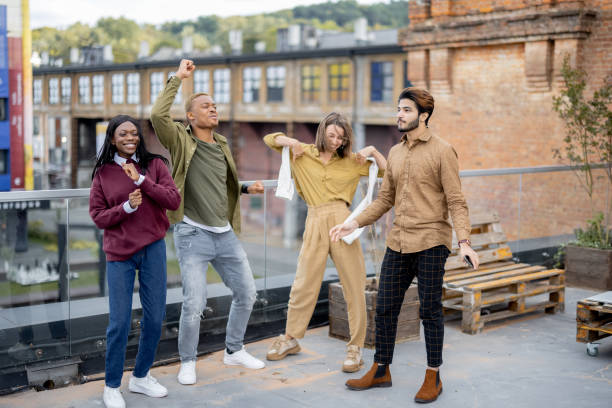istock Students celebrate on balcony at university campus 1351535826