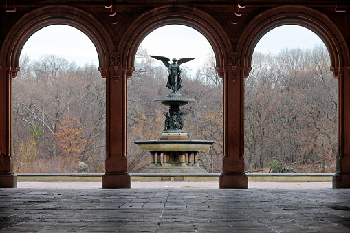 Central Park’s Bethesda fountain framed by the columns of the Bethesda arcade (New York City).