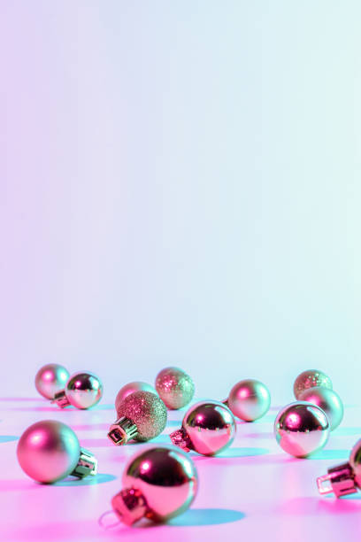 istock Christmas balls pattern neon background. Xmas bauble on abstract holiday winter gradient backdrop. Happy new year copy space. 1351535983