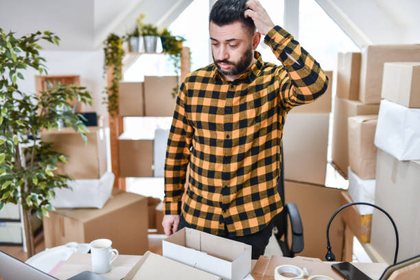 istock Confused Male Office Worker Thinking How To Put Package In Specific Box 1351536233