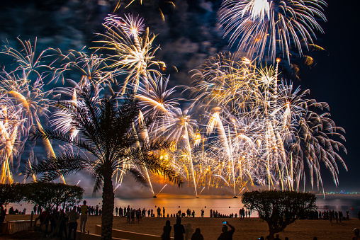 Amazing New Years eve celebration firework show above the seaside coast in Marjan Island in Ras al Khaimah emirate of United Arab Emirates aerial view