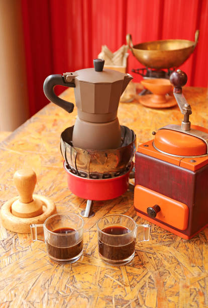 istock Two cups of fresh brewed espresso with retro coffee maker set on a table 1351539365