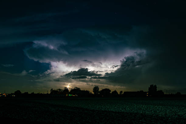 istock Autumn lightning storm over Dutch landscape at night 1351539388