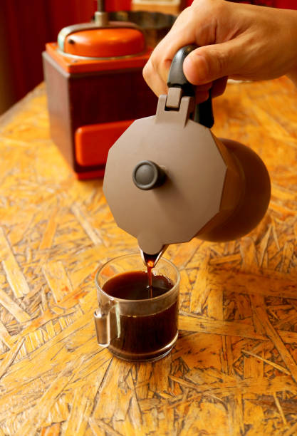 istock Hand pouring freshly brewed aromatic espresso from the coffee pot 1351539434