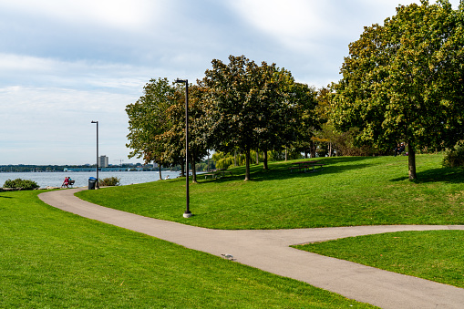 Tourists are enjoying the view of Lake Ontario in Lakefront Promenade Park, Mississauga, Canada.