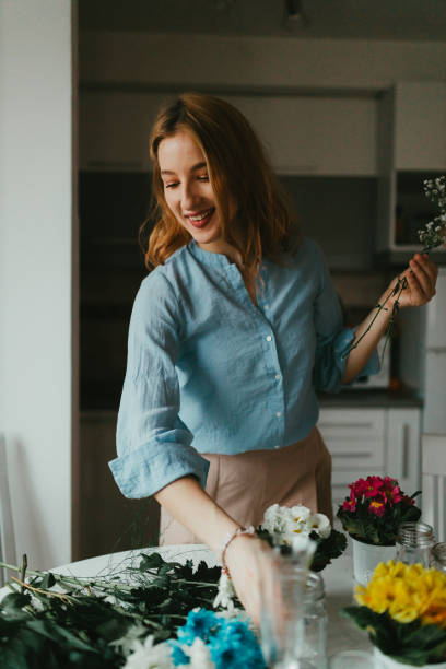 istock Woman making flower bouquets at home 1351543631
