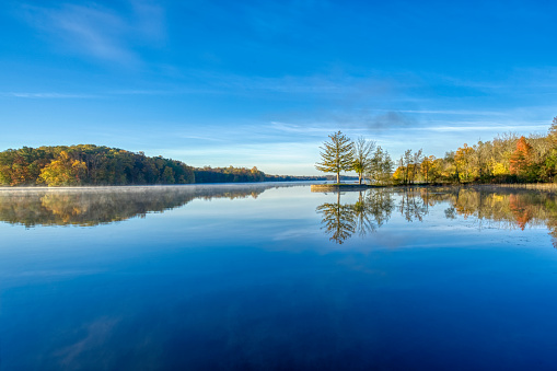 Sunrise over the colorful fall foliage in the northeast at Gifford Pinchot State Park in southern Pennsylvania USA.