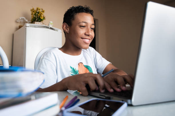 istock Boy studying at home with laptop. 1351546806