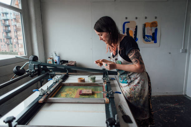 istock Artist and Printmaker working a printing press 1351547196