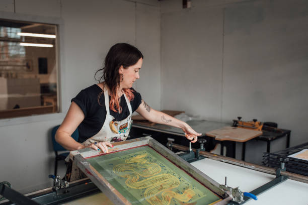istock Artist and Printmaker working a printing press 1351547199