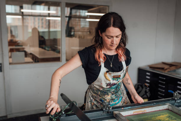 istock Artist and Printmaker working a printing press 1351547957