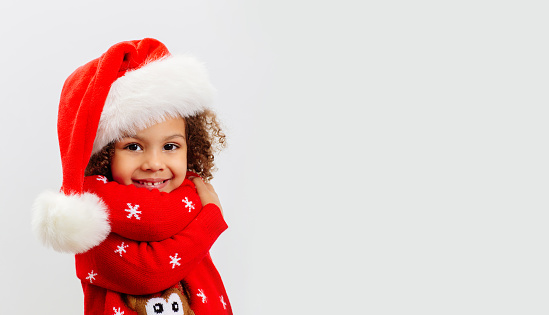 African American cute baby in a Christmas themed suit on white background. Copy space