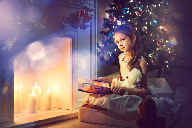 istock girl sit by the fire and dreaming about a gift 1351548233